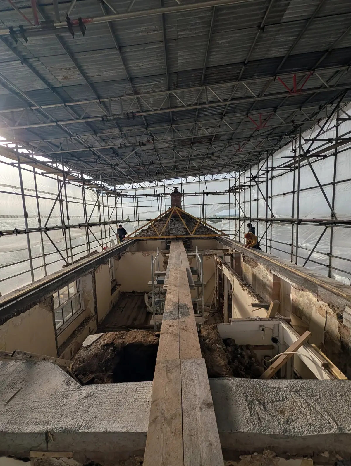 Roof stripped back under a full scaffold