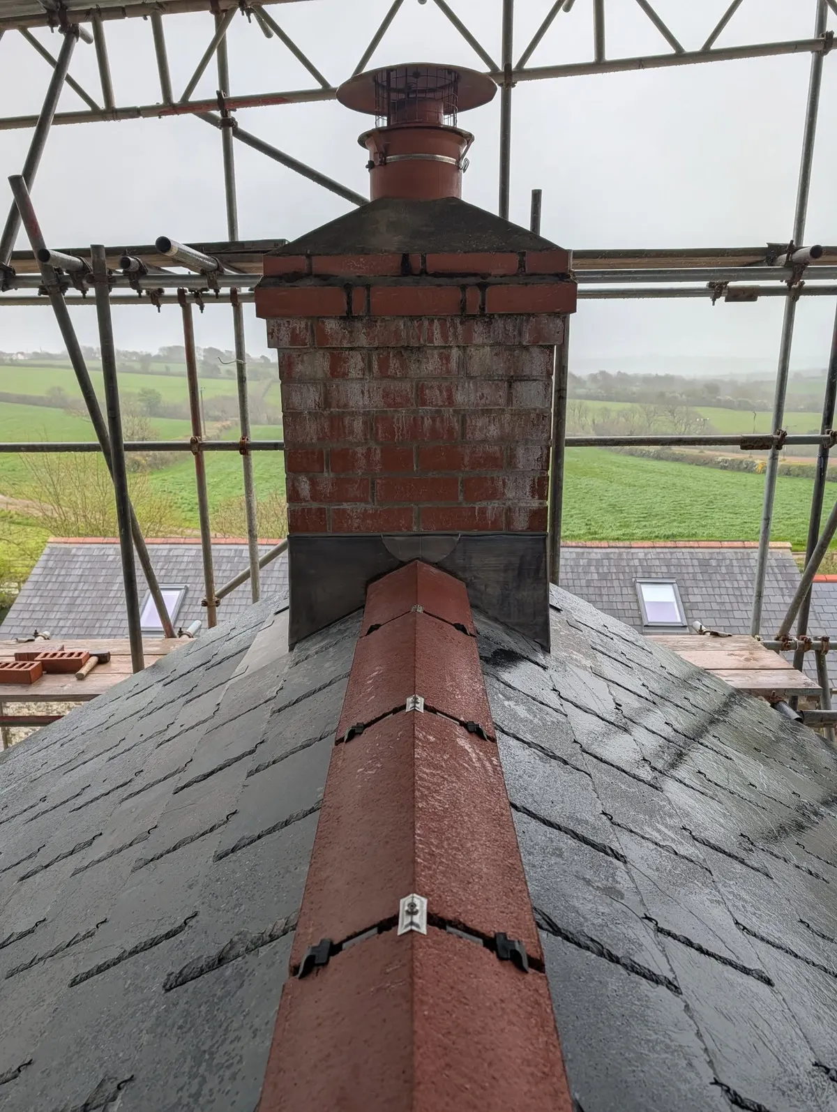 Chimney with lead flashing and red ridge tiles
