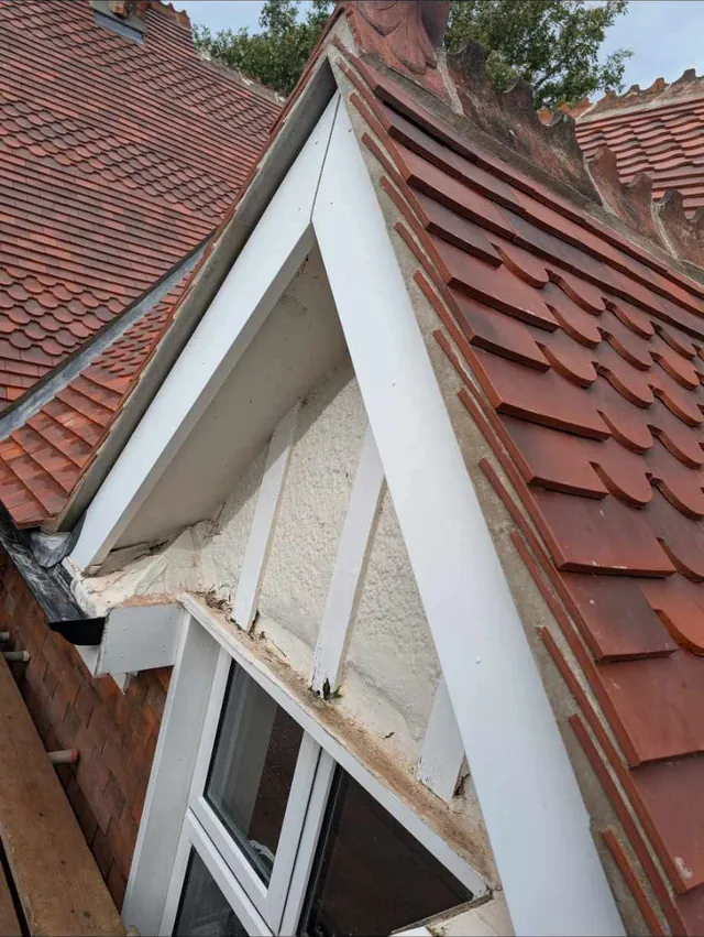 During: new plain tiles going on around a dormer