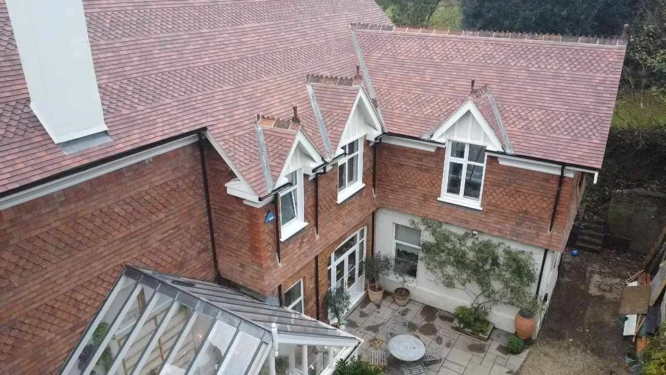 After: clay tiles, dormers and crested ridge
