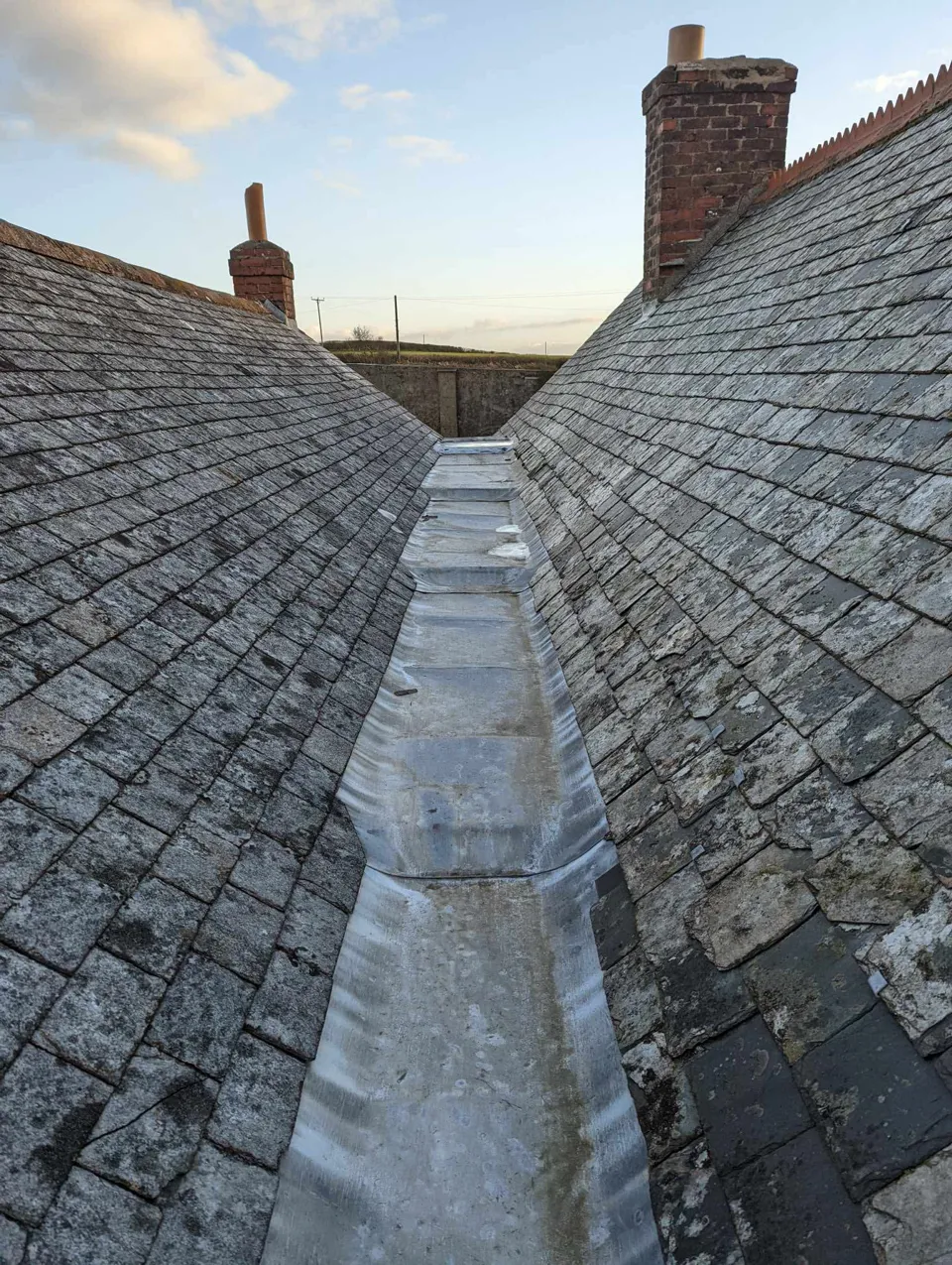 Long lead gulley running between two slate roofs